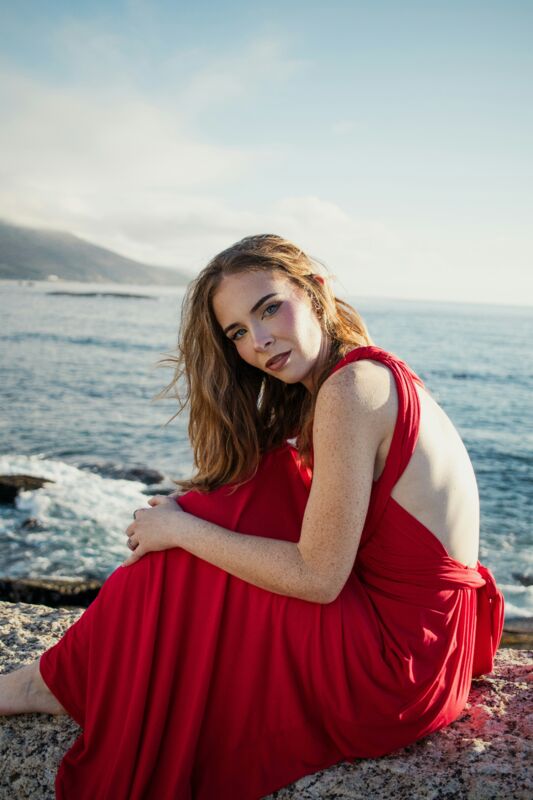 A portrait on the rocks with her eyes to camera