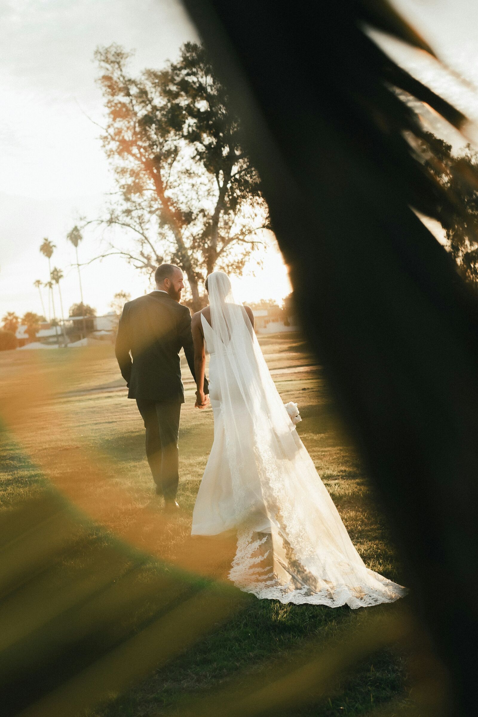 A bride and groom walking at golden hour, one frame shown edge to edge